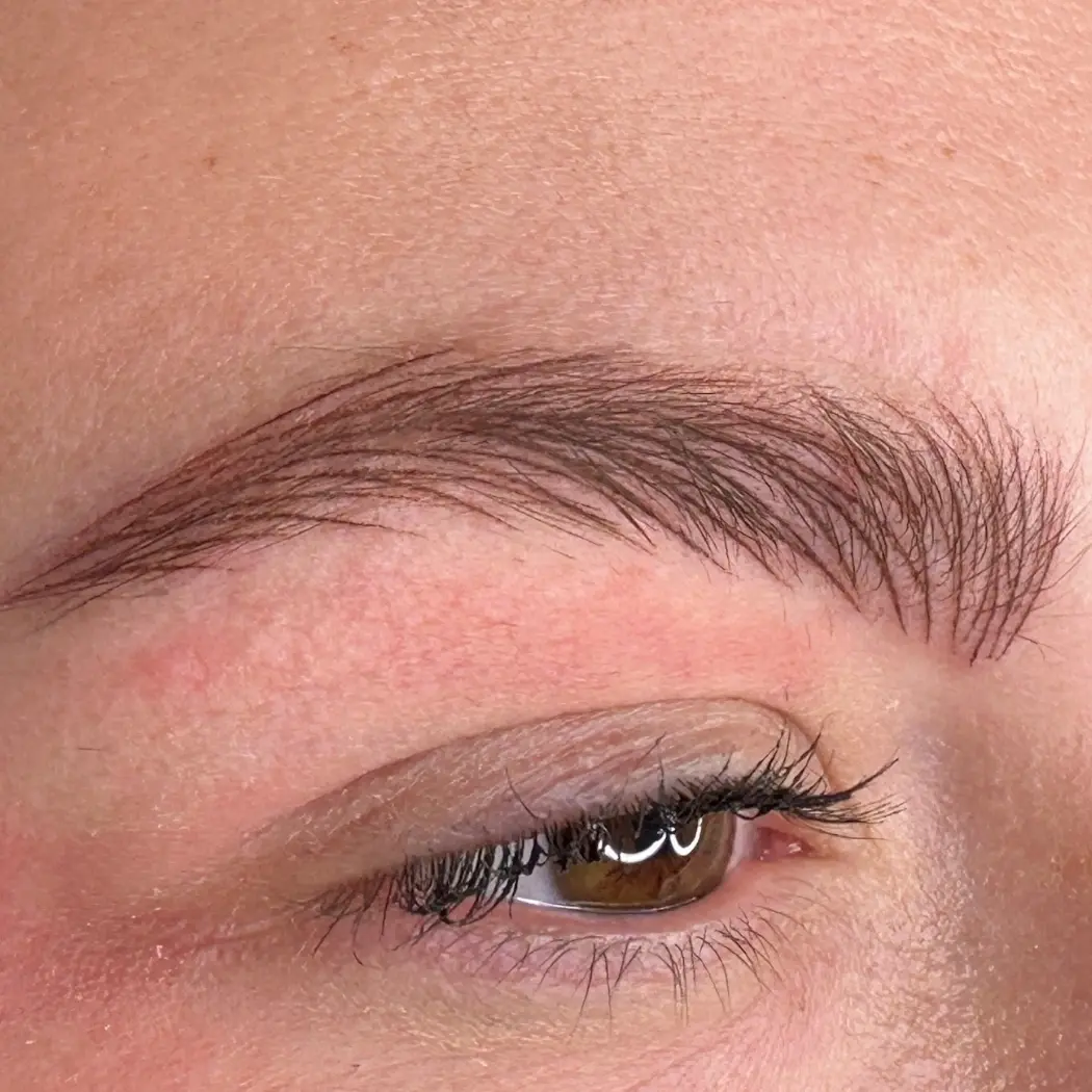 Microblading small hairstrokes on eyebrows