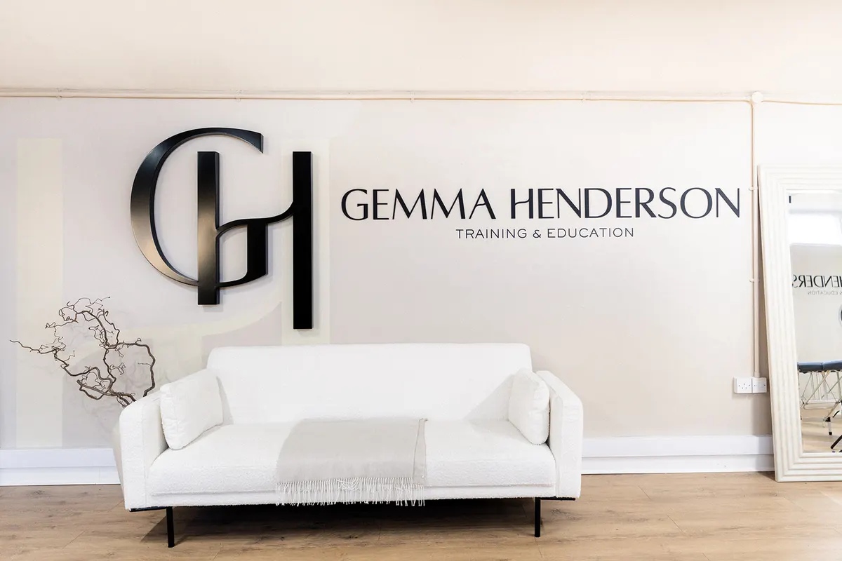 The reception area at the Gemma Henderson PMU studio in Newton Abbot, with the branded wall and seating