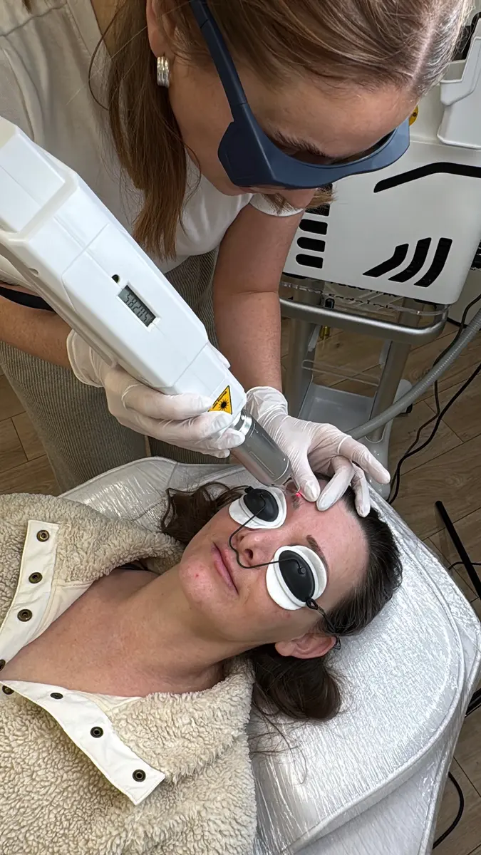 Devon carrying out laser tattoo removal on a client wearing protective eyewear, Gemma Henderson PMU